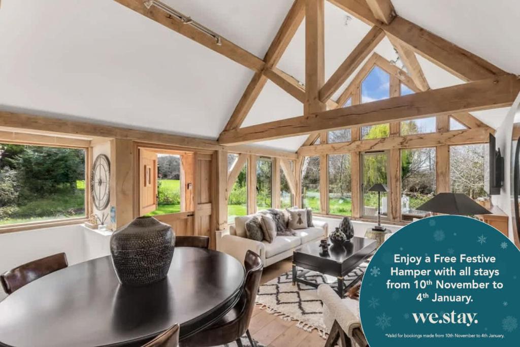 a living room with a table and chairs at Hiron's Piece and Honeysuckle Cottage - Hot Tub Packages Available in Weston Subedge