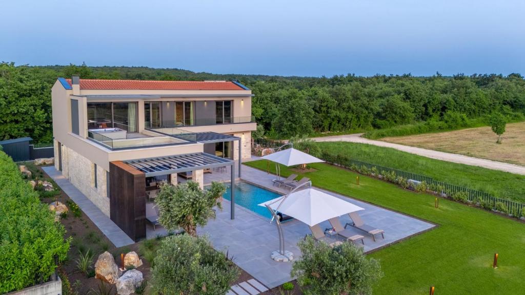 an aerial view of a house with a swimming pool at Villa Visignano with private pool, BBQ and jacuzzi in Strpačići