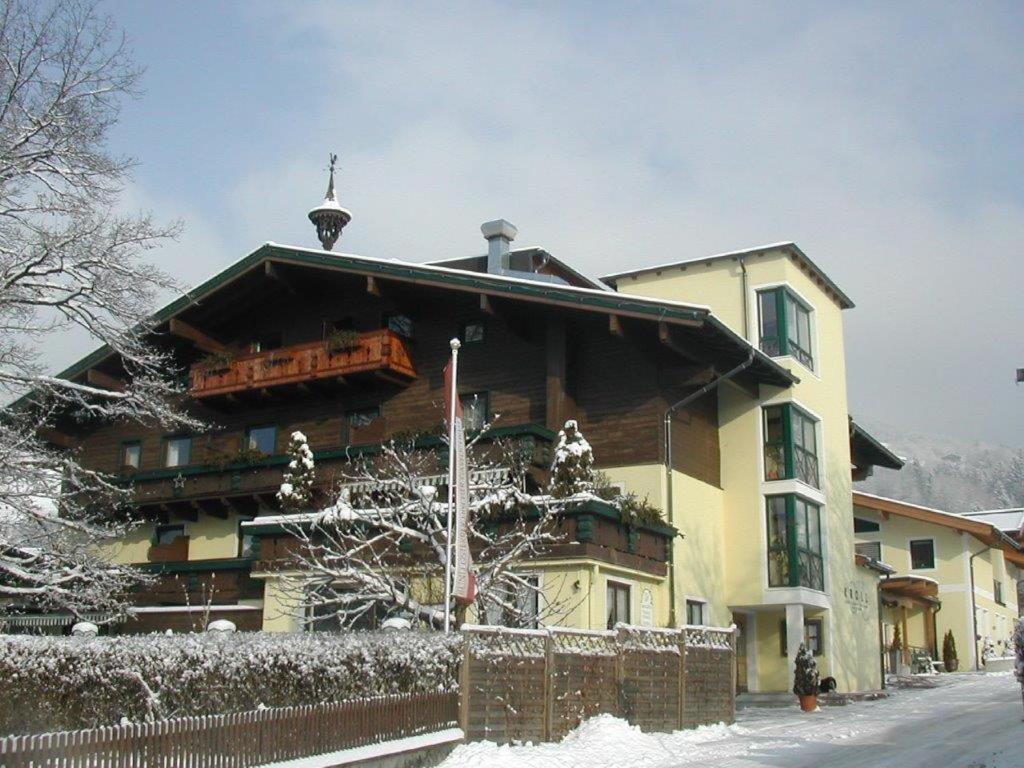 a large building with a balcony in the snow at Hotel Gasthof Kröll, 4 Skigebiete in unmittelbarer Nähe, Restaurant mit regionaler Küche in Niedernsill