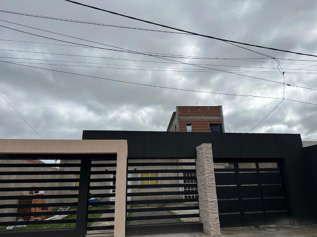 a building with two garage doors in front of a building at Quinta descansar in Concepción del Uruguay