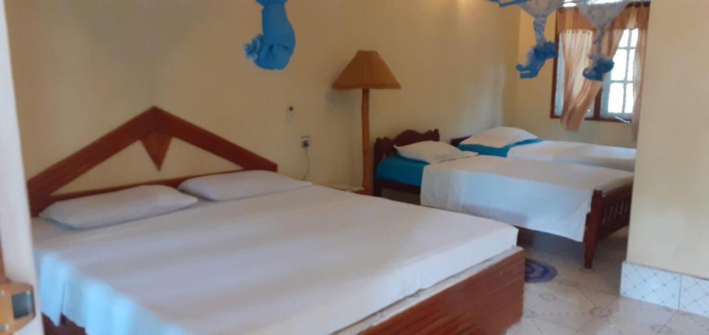 a bedroom with two beds in a room at Mango Tree Villa in Sigiriya