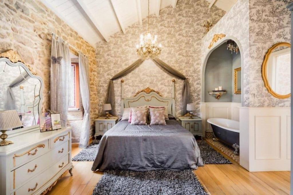 a bedroom with a bed and a bath tub in it at Casa de Carmen in Corcubión