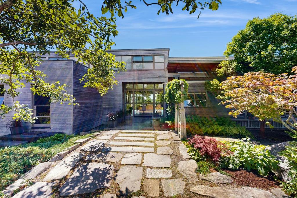 an exterior view of a house with a garden at Rackliff Island Hideaway in Spruce Head