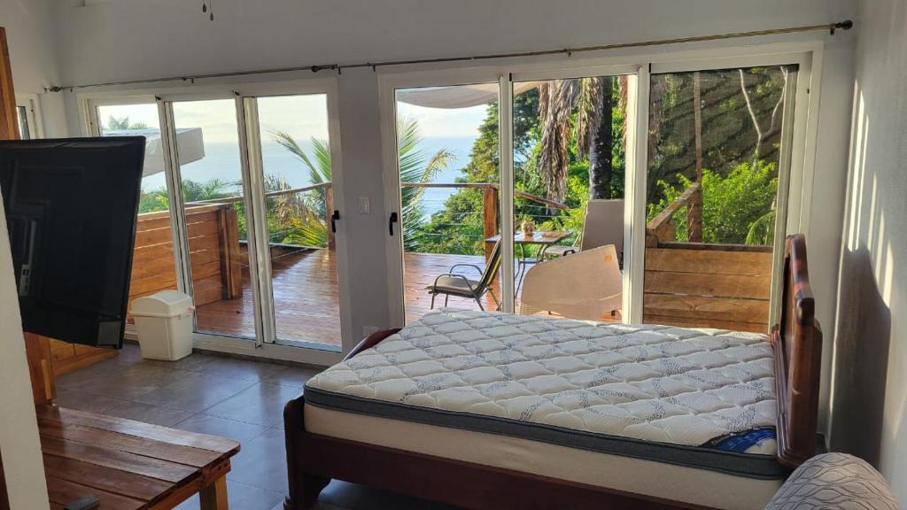 a bedroom with a bed and a balcony at Casa Boa Casita in La Abuela