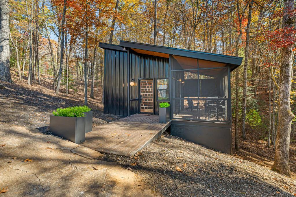 una casetta nera nel bosco di A Place & Time a Lickskillet