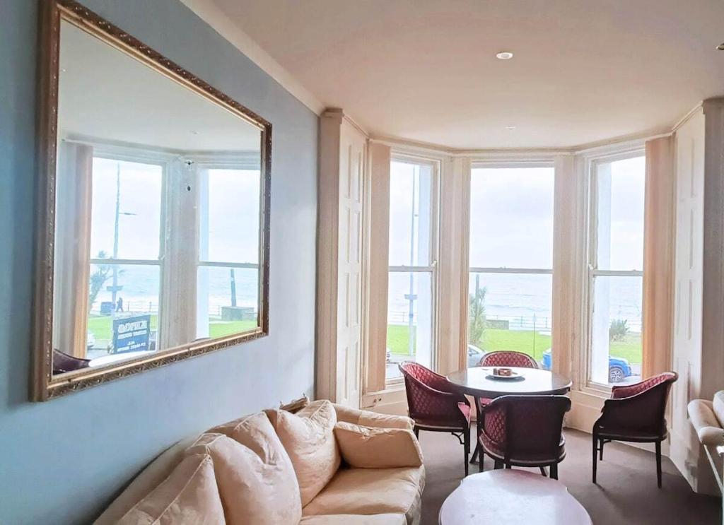 a living room with a couch and a table at Kings' House in Douglas