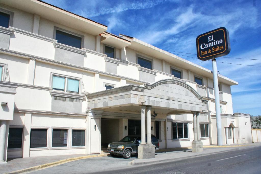 a building with a car parked in front of it at Hotel El Camino Inn & Suites in Reynosa