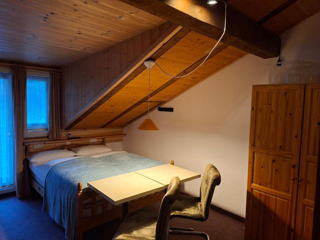 a bedroom with a bed and a table in a room at Gassermühle - Studio Appartments in Eggen