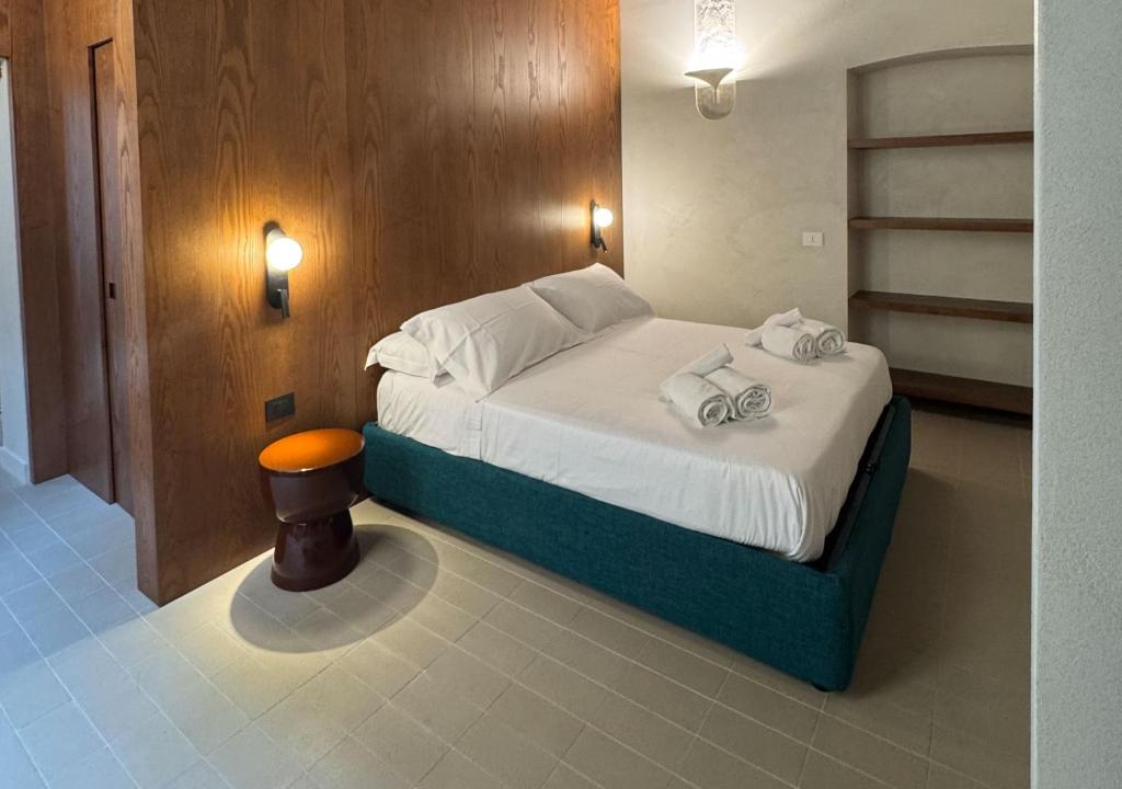 a bedroom with a bed with towels on it at Dal Console Rooms in Naples