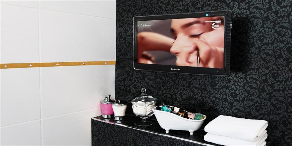 a flat screen tv hanging on a wall in a bathroom at Sultan Suites Hotel in Istanbul