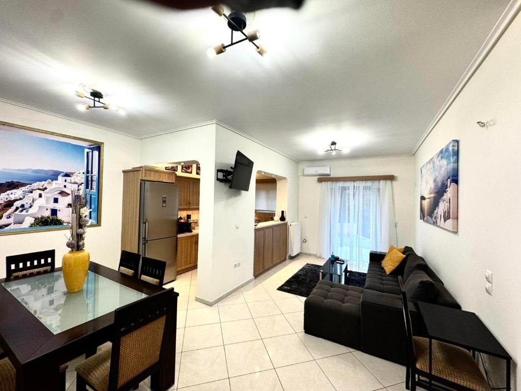 a living room with a black couch and a table at Blue Port Beach House in Rafina