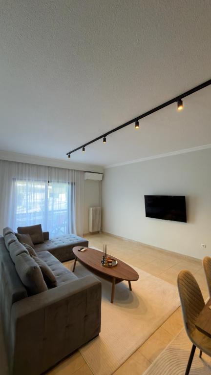 a living room with a couch and a table at J&N Living in Spata