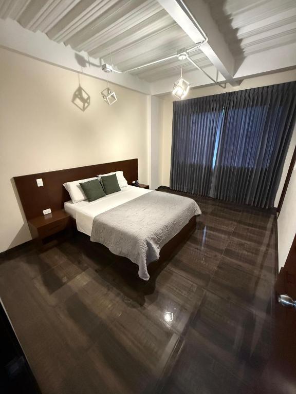 a bedroom with a large bed in a room at Hotel Fratello in Buga