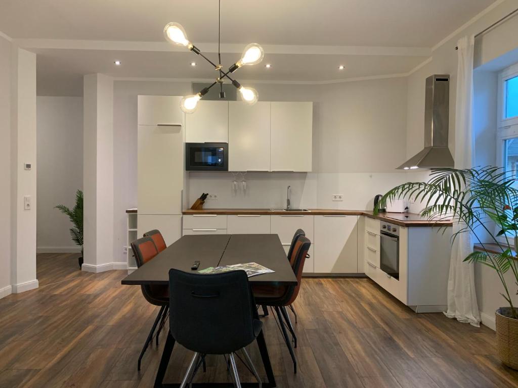 a kitchen with a table and chairs in a kitchen at Villa Alexandra 1897 Wohnung Vilma in Bad Wildungen