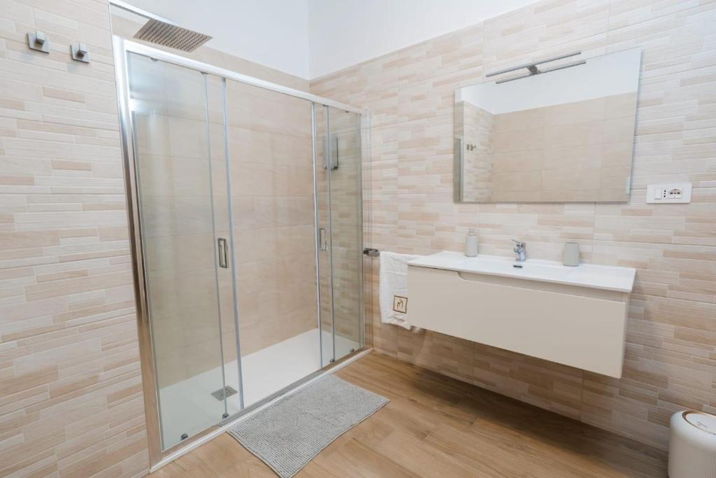 a bathroom with a glass shower and a sink at IL CENTRO rooms in Cerignola