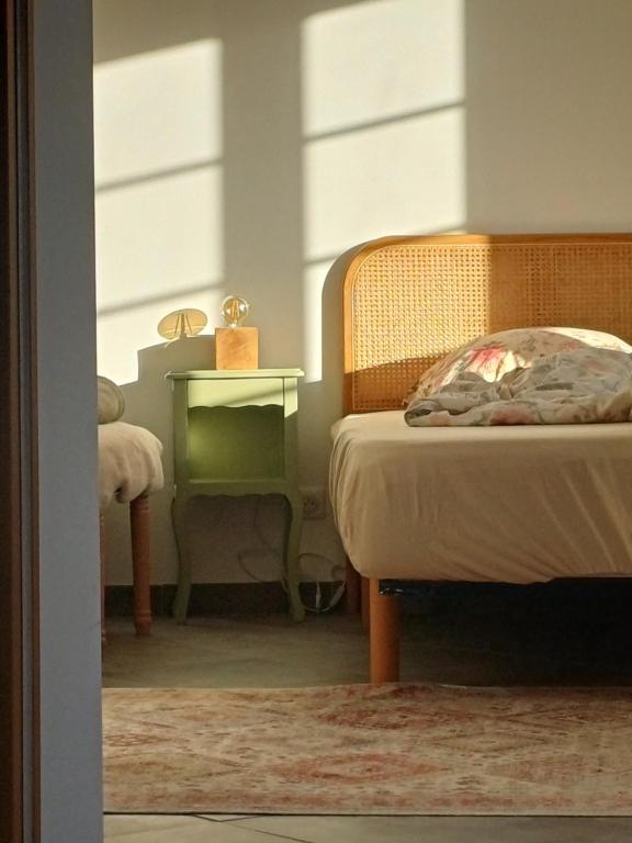 a bedroom with a bed and a table with a night stand at À côté du Pont Vieux - By the Old Bridge in Sospel