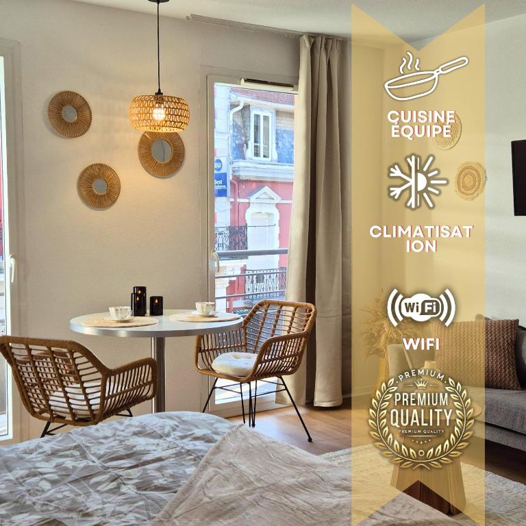 a room with a table and chairs and a dining room at L'épure - Clim - Confort - Moderne in Lourdes