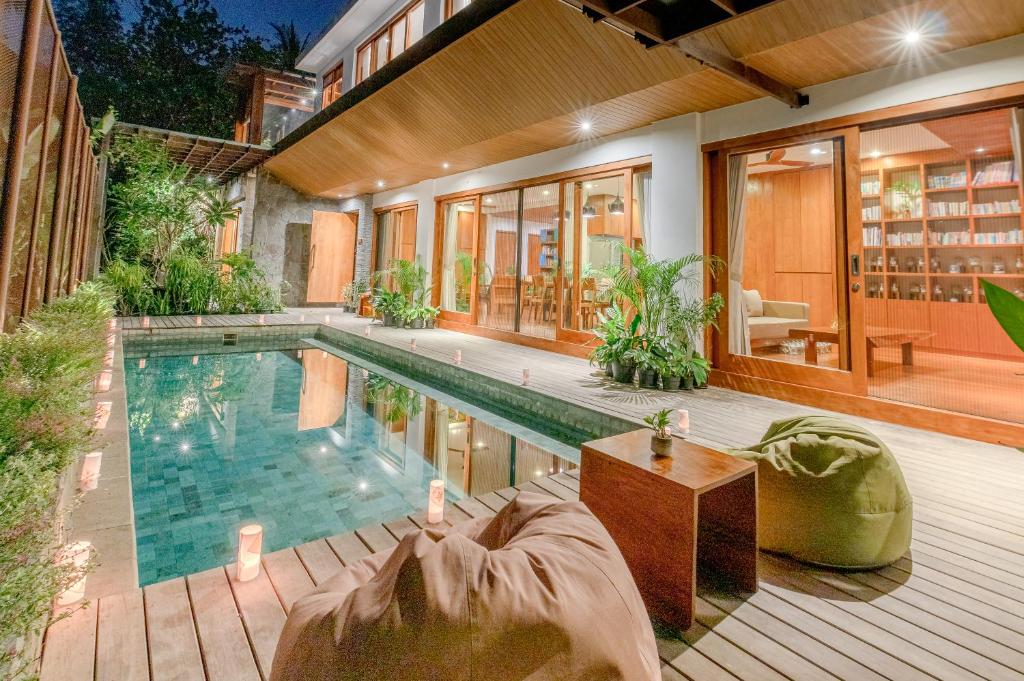 a swimming pool in the backyard of a house at The Vinaya Boutique Hotel in Ubud