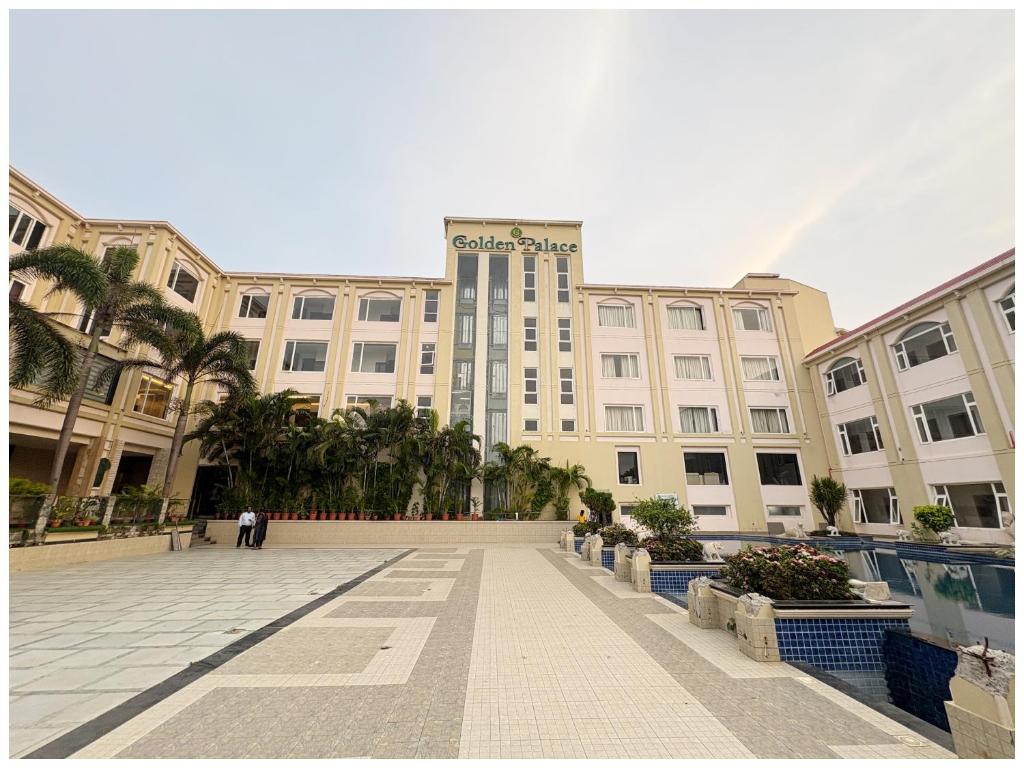 a large building with a clock tower in front of it at Hotel Seafaceing Golden- Palace - Swimming Pool and Private Beach Facilities in Puri