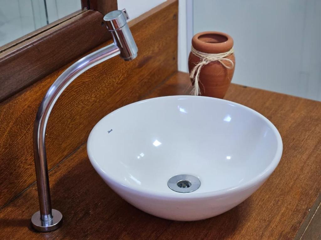 a white sink with a faucet on a counter at FLATS SHALON - MORRO DE SÃO PAULO in Morro de São Paulo