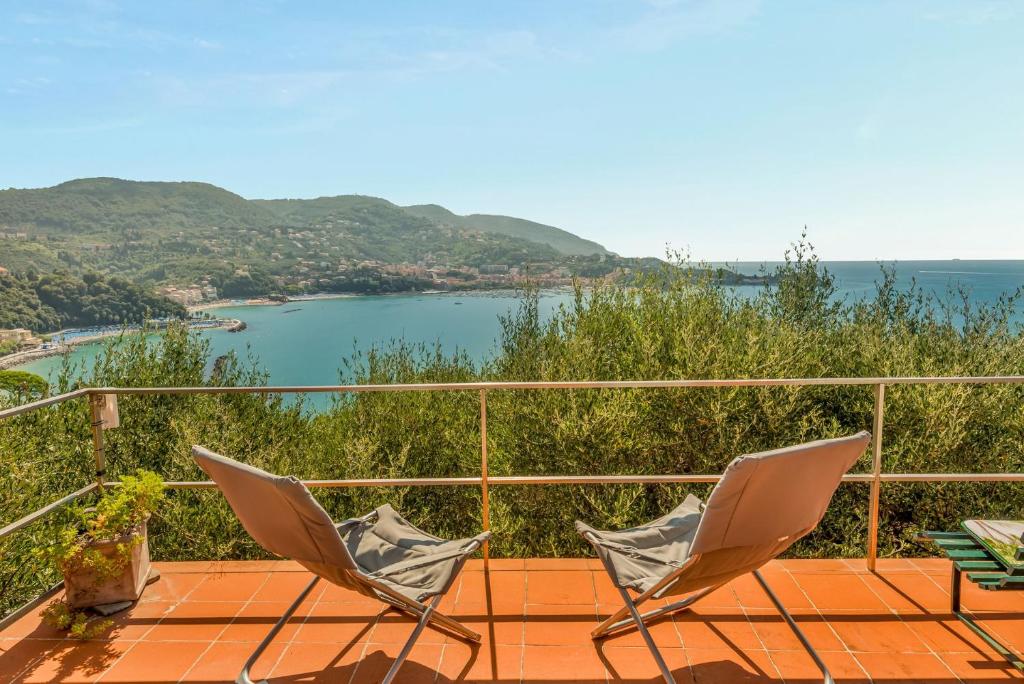 two chairs on a balcony with a view of the water at La dimora dell'artista sea view free parking in San Terenzo