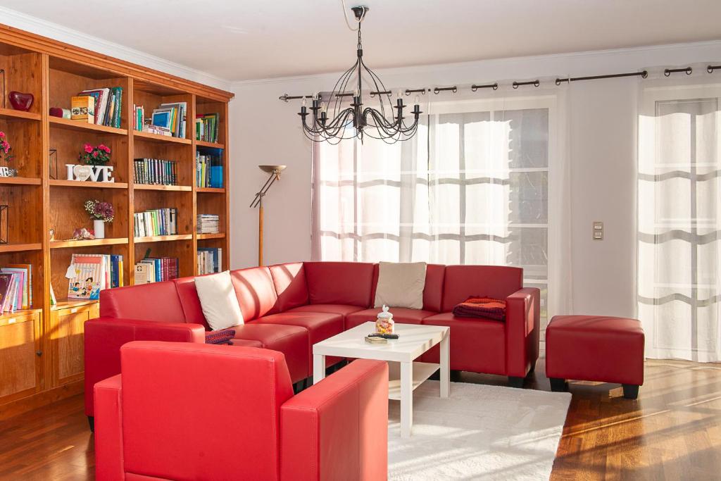 a living room with a red couch and a table at Ferienhaus Eisenach in Eisenach