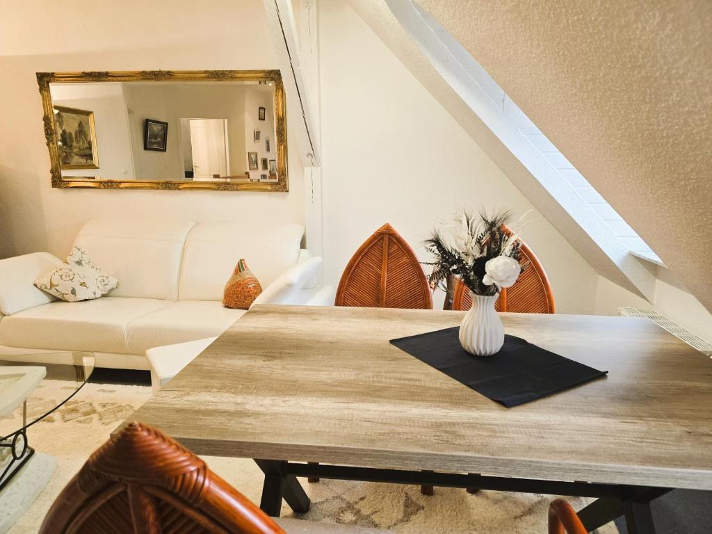 a dining room with a table and a mirror at Ostseeloft Wischuer in Rerik