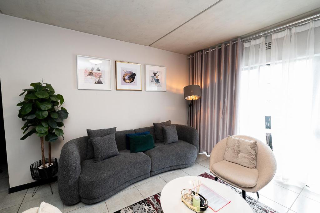 a living room with a couch and a table at K47 propertyzz in Midrand