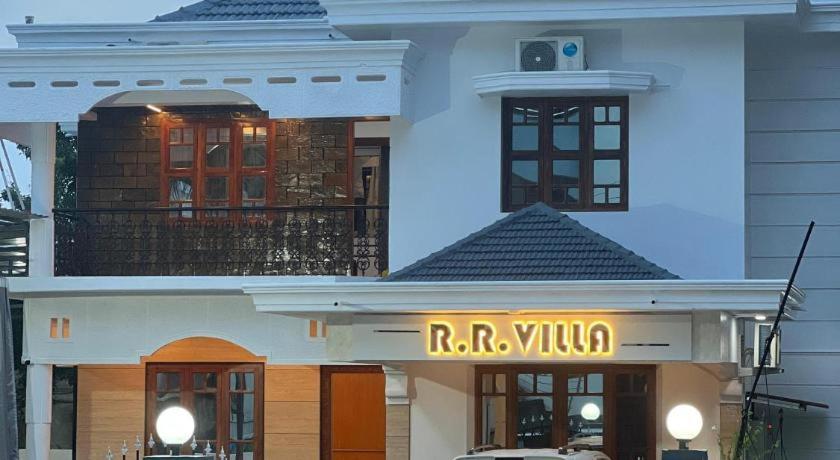 a building with a raja virus sign in front of it at RR Villa in Bantvāl