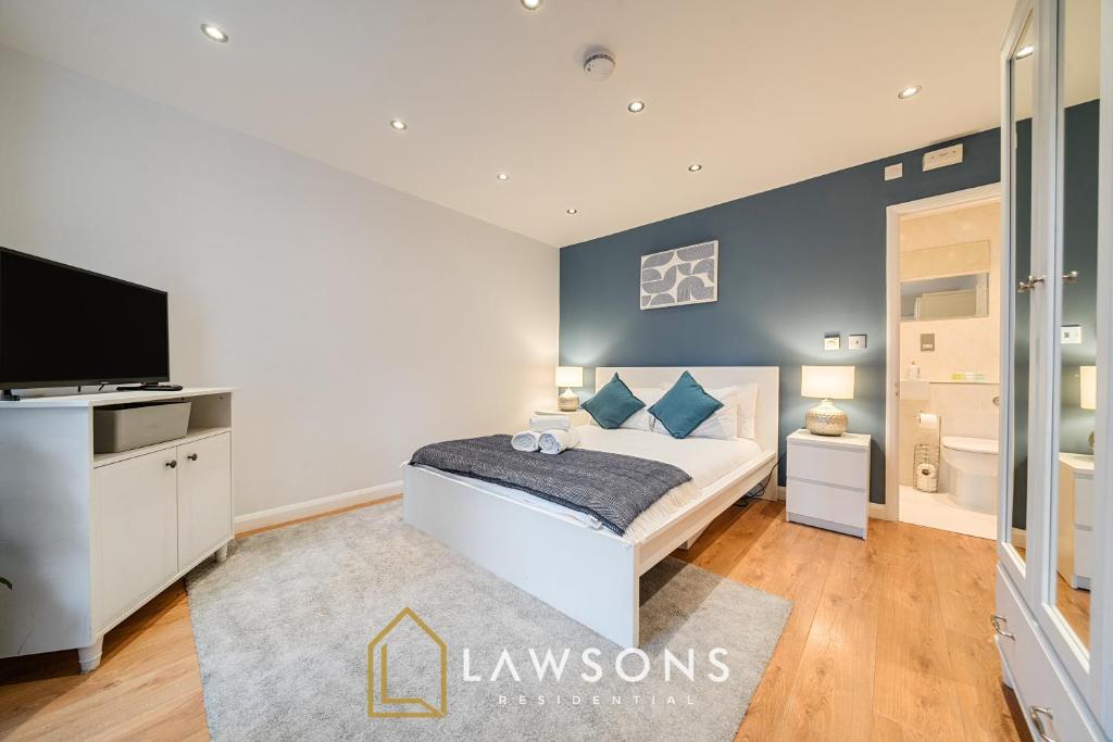 a bedroom with a bed and a tv in it at 2BR House, Walk to Windsor Castle, Parking for 2 in Windsor