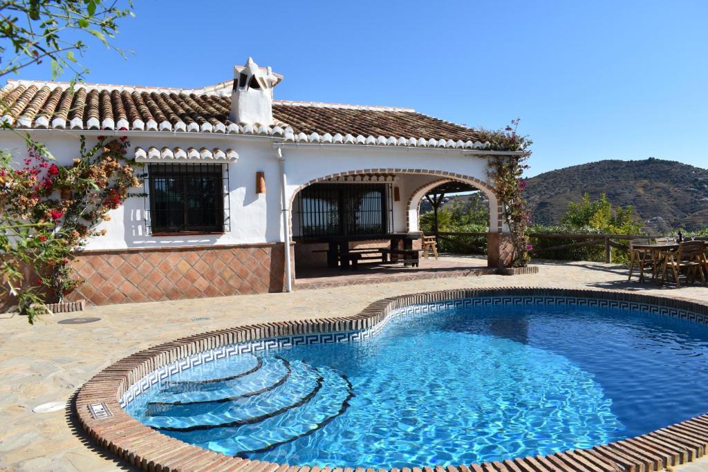 a swimming pool in front of a house at Finca Higueron with private Pool in Río