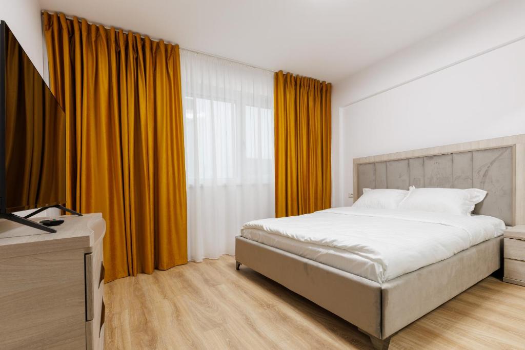 a bedroom with a bed and a large window at Urban Retreat 1BDR Craiova in Craiova