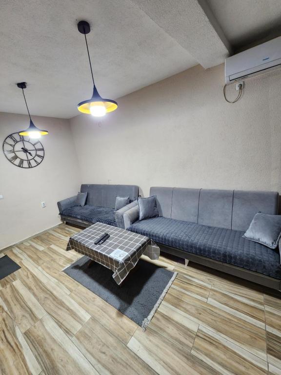 a living room with a couch and a table at Arel's Home in Prizren