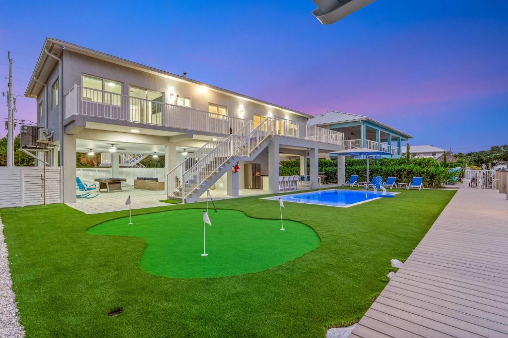 a house with a putting green in front of it at Surfstream Edge in Marathon Airport