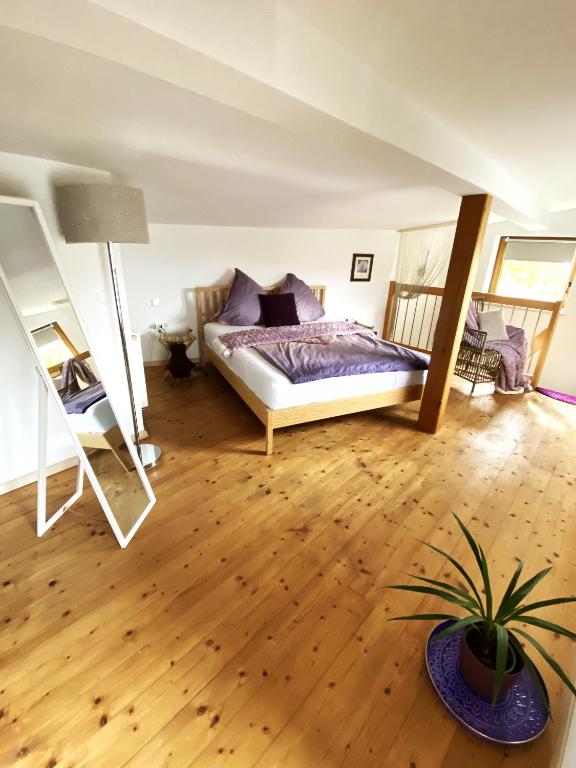 a bedroom with a bed and a potted plant at "Nestl" in Bad Häring