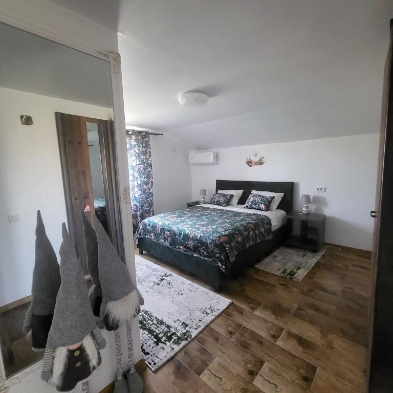 a bedroom with a bed and a mirror at Pensiunea Balta Lazar in Alexandria