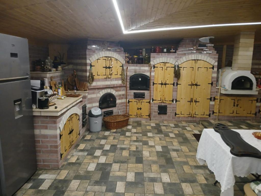 a large kitchen with yellow doors and a kitchen with a stove at Pensiunea Balta Lazar in Alexandria