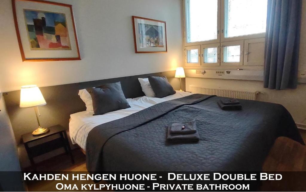 a bedroom with a large bed with two bags on it at Hotel 24 - Karihaara - Kemi in Kemi