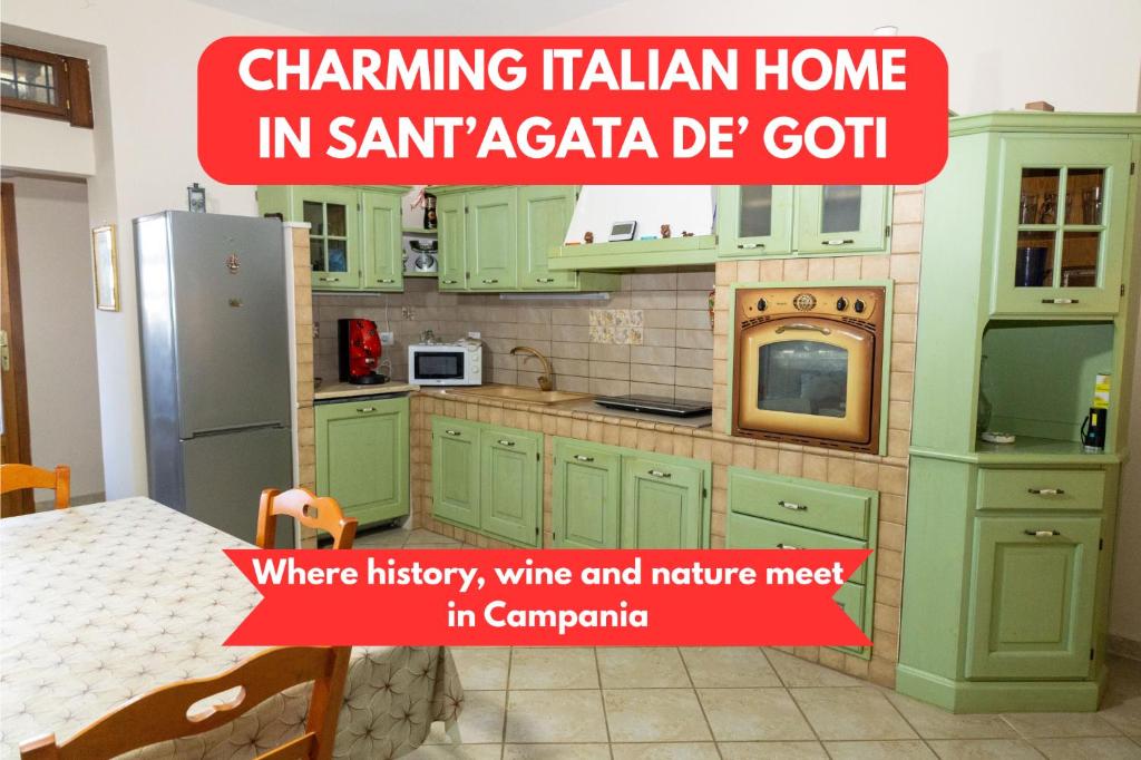 a kitchen with green cabinets and a sign that says channeling italian home in at View, Terrace & Comfort in Sant'Agata de' Goti in SantʼAgata deʼ Goti