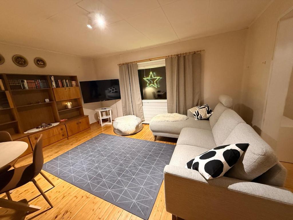 a living room with a couch and a table at Holiday home on the edge of the woods in Kemijärvi