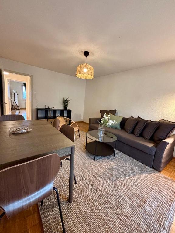 a living room with a couch and a table at Live Zurich in Cozy Apartment in Zürich