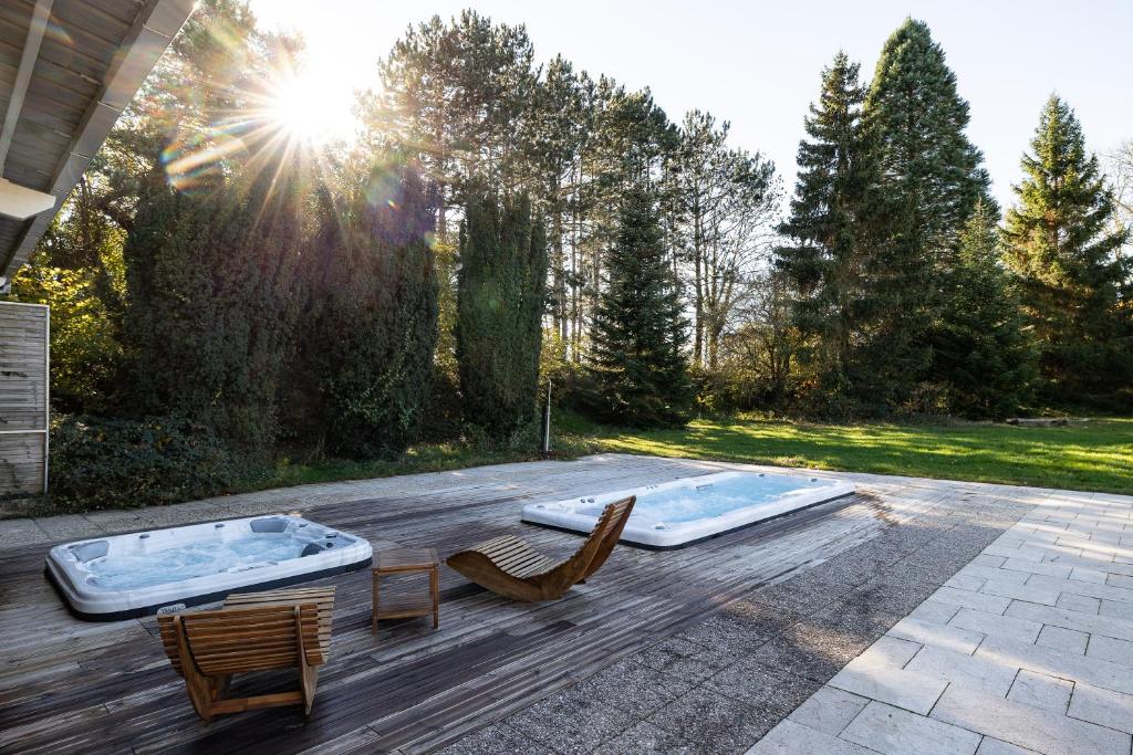 a patio with two chairs and a hot tub at Gîte Mattaincourt in Mattaincourt