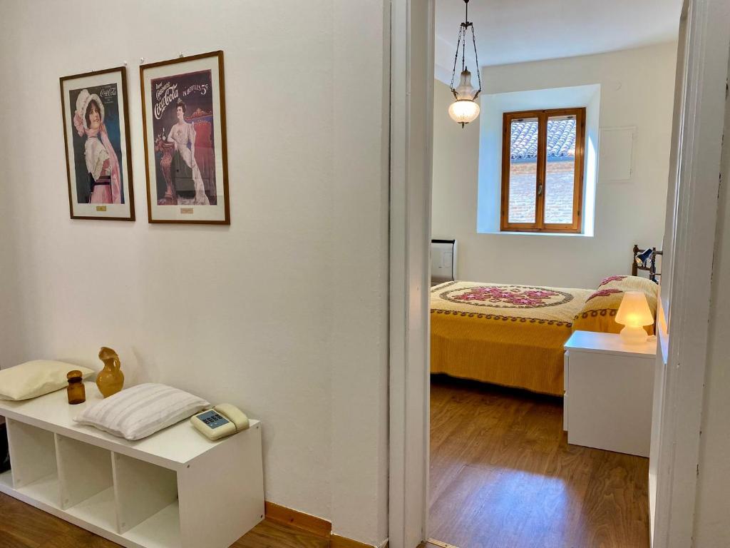 a bedroom with a bed and a table in a room at Teatro Inn - Timeless Charm in Correggio