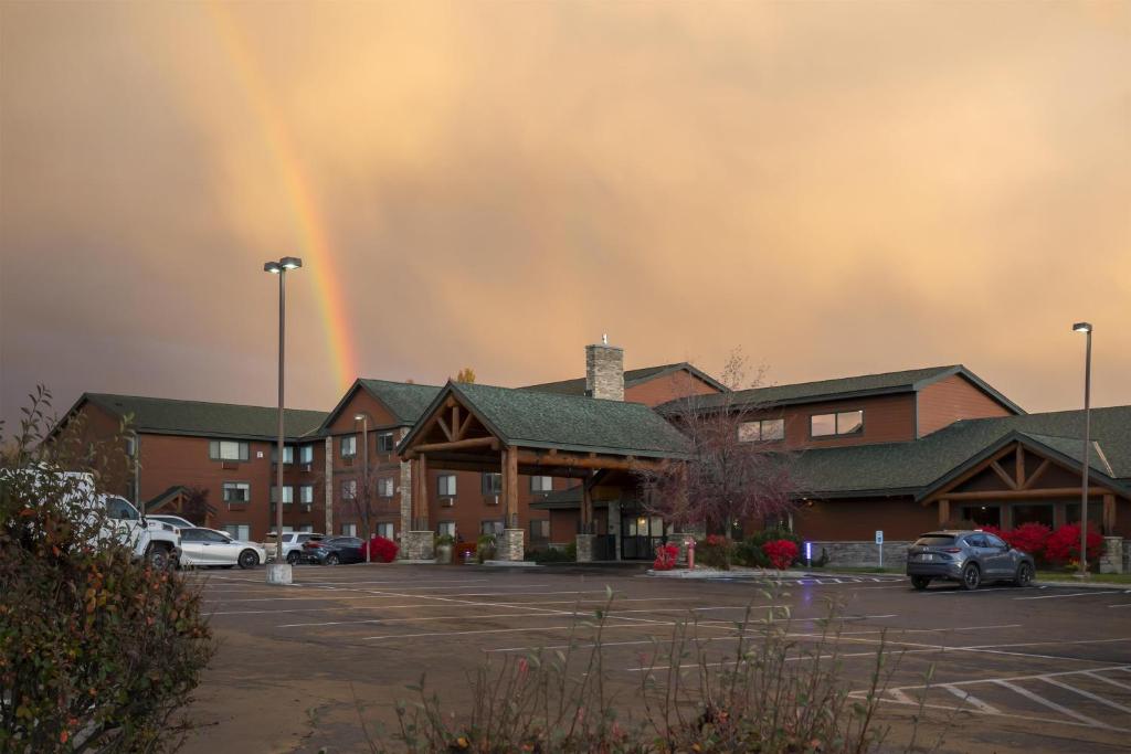 a rainbow over a building with a parking lot at Best Western Plus McCall Lodge and Suites in McCall