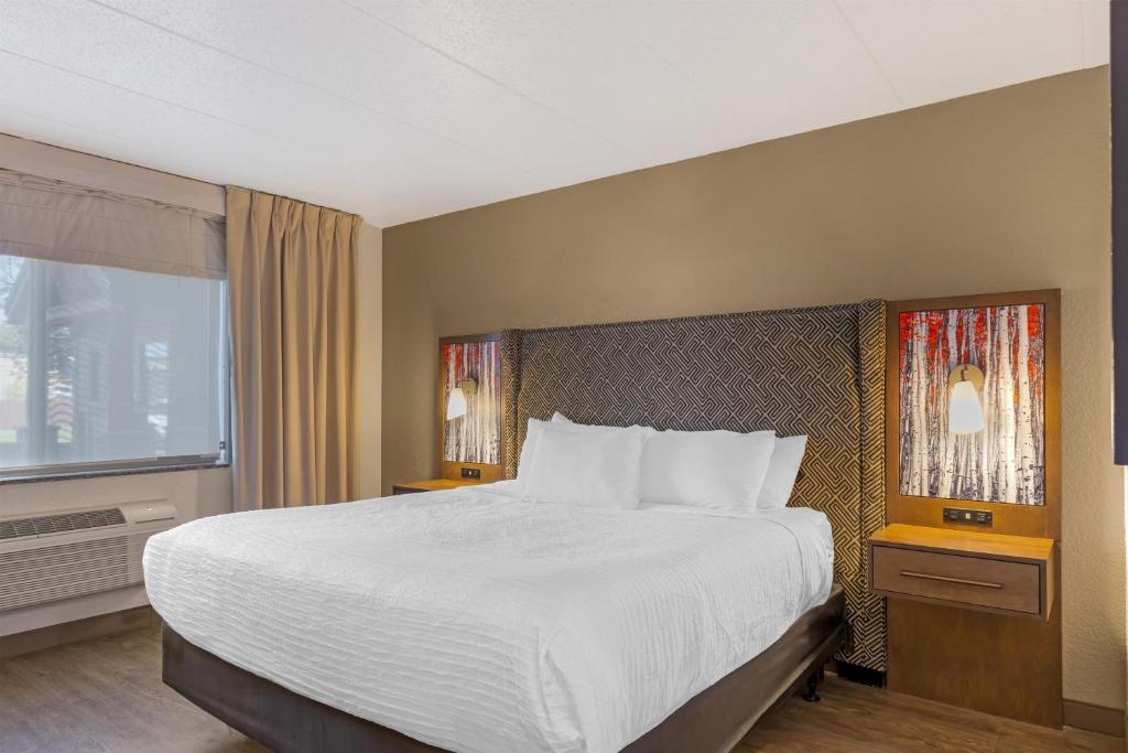 a bedroom with a large bed and a window at Best Western Plus McCall Lodge and Suites in McCall