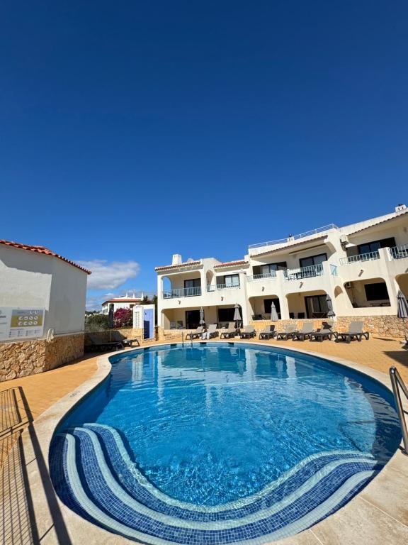 a large swimming pool in front of a building at Casa Julio-Rooftop Terrace & Pool 5 Min to Beach in Carvoeiro