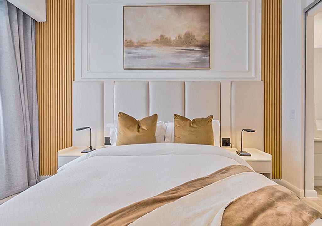 a bedroom with a large white bed with pillows at MNM Luxury Suit 424A in Pretoria