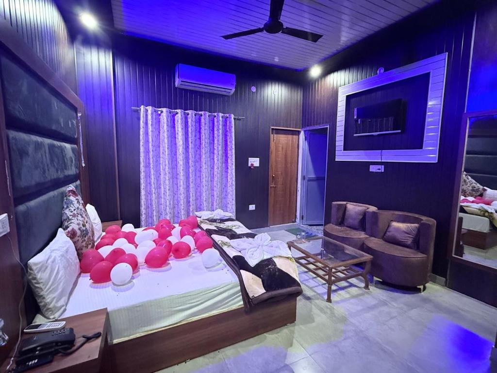 a room with a large bed with red balls on it at The Hotel Moon in Pāonta Sāhib