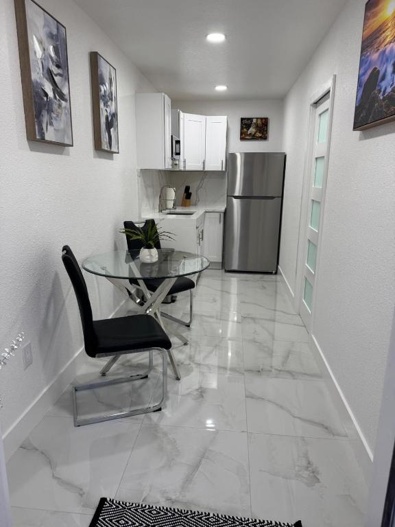a kitchen with a glass table and a refrigerator at Apartment in Tampa