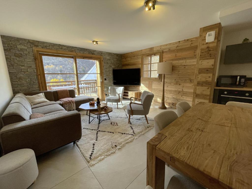 a living room with a couch and a table at Duplex Haut de Gamme neuf - 10 personnes - App 004 in Saint-Sorlin-dʼArves